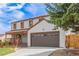 Charming two-story home featuring a covered front porch, a two car garage, and mature landscaping at 4808 S Ward Way, Morrison, CO 80465