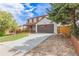 Quaint two-story home featuring a cozy front porch, attached garage, and low maintenance landscaping at 4808 S Ward Way, Morrison, CO 80465