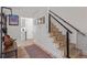 Inviting hallway features modern stairs, a bench, and access to the kitchen at 4808 S Ward Way, Morrison, CO 80465