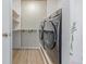 Laundry room featuring shelving and a modern front-load washer and dryer set at 4808 S Ward Way, Morrison, CO 80465