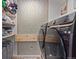 Well-organized laundry room features modern machines and storage shelves for a functional space at 4808 S Ward Way, Morrison, CO 80465