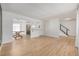 Spacious living room shows open floor plan to kitchen with wood floors and stainless appliances at 4808 S Ward Way, Morrison, CO 80465