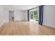 Bright living room featuring wood floors, access to dining, and sliding glass doors at 4808 S Ward Way, Morrison, CO 80465