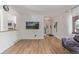Bright, open living room showcasing sleek wood floors and easy access to main entry and kitchen at 4808 S Ward Way, Morrison, CO 80465