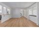 Light-filled living room with wood floors, leading to stairs and other rooms at 4808 S Ward Way, Morrison, CO 80465