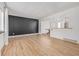 Bright living room features new floors, neutral paint, and updated lighting fixtures, offering a modern, inviting space at 4808 S Ward Way, Morrison, CO 80465