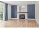 Inviting living room with wood floors, a brick fireplace, and sliding glass doors at 4808 S Ward Way, Morrison, CO 80465