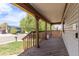 Spacious front porch offering a relaxing outdoor space with wood flooring and railing at 4808 S Ward Way, Morrison, CO 80465