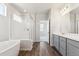 A modern bathroom features a glass-enclosed shower, soaking tub, and double sink vanity at 1281 Loraine N Cir, Lafayette, CO 80026