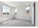 Bright bedroom with three windows, neutral carpet, and closet with sliding doors at 1281 Loraine N Cir, Lafayette, CO 80026