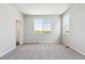 A large bedroom with neutral walls and carpet offers natural light and generous space at 1281 Loraine N Cir, Lafayette, CO 80026