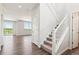 Bright entryway features wood floors, a staircase with white railings, and views into the living area at 1281 Loraine N Cir, Lafayette, CO 80026