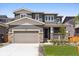 Charming two-story home featuring stone accents, a covered front porch, a well-maintained lawn and two car garage at 1281 Loraine N Cir, Lafayette, CO 80026
