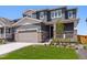 Charming two-story home featuring stone accents, a covered front porch, a well-maintained lawn and two car garage at 1281 Loraine N Cir, Lafayette, CO 80026