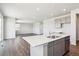 Open kitchen with stainless appliances, a center island with a sink and views into the living area at 1281 Loraine N Cir, Lafayette, CO 80026