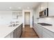 Bright kitchen features stainless steel appliances, a center island with a sink and wood flooring at 1281 Loraine N Cir, Lafayette, CO 80026