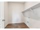 Well lit laundry room with wood look floors and built in shelf at 1281 Loraine N Cir, Lafayette, CO 80026