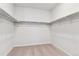 A walk-in closet with neutral walls, carpet, and wraparound closet rod offers storage space at 1281 Loraine N Cir, Lafayette, CO 80026