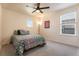 Bedroom with carpeted floor, two windows and a vibrant quilt-covered bed at 11933 Norfolk Ct, Commerce City, CO 80022