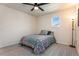 Bedroom with carpeted floor, one window and a vibrant quilt-covered bed and ceiling fan at 11933 Norfolk Ct, Commerce City, CO 80022