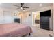 Primary bedroom with ensuite bathroom, neutral walls, carpet and ceiling fan at 11933 Norfolk Ct, Commerce City, CO 80022