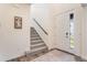 Bright entryway with carpeted stairs, wood flooring and access to front door at 11933 Norfolk Ct, Commerce City, CO 80022