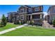 Charming front exterior view of home with covered porch, walkway, and green grass at 11933 Norfolk Ct, Commerce City, CO 80022