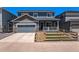 Traditional home with a well-manicured lawn, front porch, and fenced-in front yard at 11933 Norfolk Ct, Commerce City, CO 80022