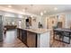 Spacious kitchen and dining area with stainless steel appliances, granite countertops, and hardwood floors at 11933 Norfolk Ct, Commerce City, CO 80022