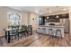 Bright kitchen with stainless steel appliances, granite countertops, and dining table seating at 11933 Norfolk Ct, Commerce City, CO 80022