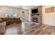 Inviting living room featuring a cozy fireplace with stone surround and natural light from large windows at 11933 Norfolk Ct, Commerce City, CO 80022