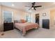 Comfortable main bedroom with plush carpet, ceiling fan and walk-in closet at 11933 Norfolk Ct, Commerce City, CO 80022