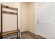 Mudroom with wood laminate floors, coat rack, and view of the front door at 11933 Norfolk Ct, Commerce City, CO 80022