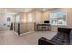 Spacious upstairs office with sleek railing, modern desk, chair, sofa and window view at 11933 Norfolk Ct, Commerce City, CO 80022