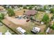 Scenic aerial view of the property and surrounding landscape featuring mature trees and spacious lawn at 1195 W 70Th Ave, Denver, CO 80221