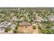 Wide aerial shot showcases the home's setting among tree-lined streets and other residences at 1195 W 70Th Ave, Denver, CO 80221