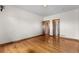Large bedroom featuring hardwood floors and multiple doorways, enhancing flow and accessibility at 1195 W 70Th Ave, Denver, CO 80221
