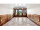 An elegant dining room with hardwood trim and statement windows with decorative chandelier overhead at 1195 W 70Th Ave, Denver, CO 80221