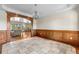 Open-concept floor plan showcasing dining and living areas with hardwood floors and trim at 1195 W 70Th Ave, Denver, CO 80221