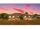 Charming single-story brick home with well-maintained lawn and inviting front porch at sunset at 1195 W 70Th Ave, Denver, CO 80221