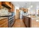 Modern kitchen with stainless steel appliances, custom cabinetry, and center island at 1195 W 70Th Ave, Denver, CO 80221