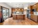 Modern kitchen with stainless steel appliances, custom cabinetry, and center island at 1195 W 70Th Ave, Denver, CO 80221