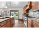 Gourmet kitchen features a spacious island, stainless steel appliances, and custom cabinetry at 1195 W 70Th Ave, Denver, CO 80221