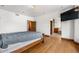 Hardwood floors and an archway to a well-appointed ensuite bathroom elevate this main bedroom at 1195 W 70Th Ave, Denver, CO 80221