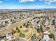 Panoramic aerial view featuring a mix of residential homes, parks, and distant mountain ranges at 8815 W Quarto Cir, Littleton, CO 80128