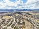Expansive aerial view capturing the rolling landscape, community, and distant mountain range at 8815 W Quarto Cir, Littleton, CO 80128