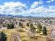 Wide aerial view showcasing neighborhood, landscape and mountain views at 8815 W Quarto Cir, Littleton, CO 80128