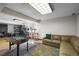 Spacious finished basement featuring a foosball table, sectional sofa, and a work area with dual monitors at 8815 W Quarto Cir, Littleton, CO 80128