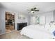 Well-lit bedroom featuring a spacious closet and a ceiling fan at 8815 W Quarto Cir, Littleton, CO 80128