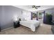 Bright bedroom with plush carpet, ceiling fan and a view to the outside at 8815 W Quarto Cir, Littleton, CO 80128